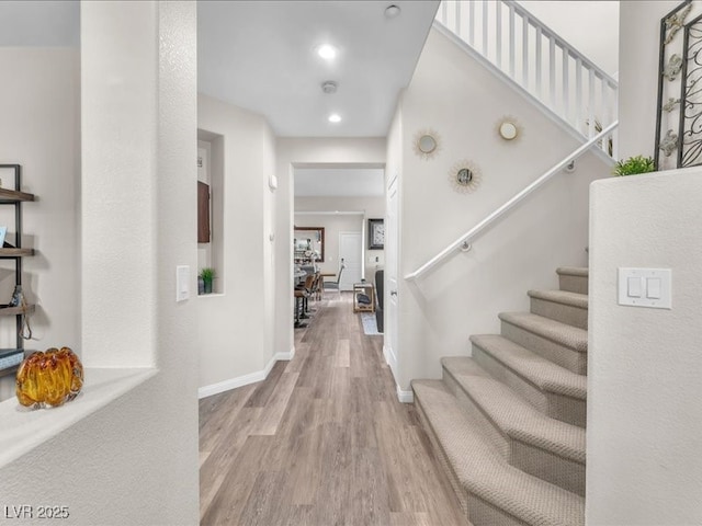 foyer featuring stairway, recessed lighting, light wood-style floors, and baseboards