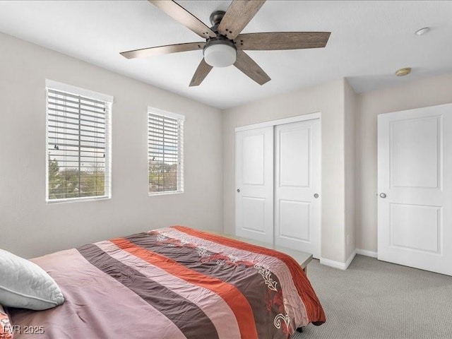 carpeted bedroom featuring baseboards, a closet, and ceiling fan