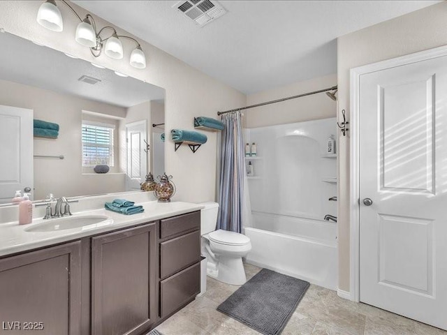 bathroom featuring visible vents, vanity, toilet, and shower / bath combo with shower curtain