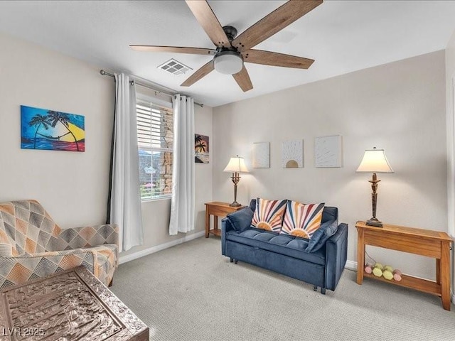 carpeted living area with visible vents, baseboards, and ceiling fan