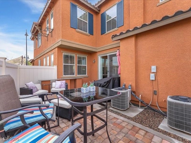 view of patio / terrace with central air condition unit, outdoor dining space, and fence