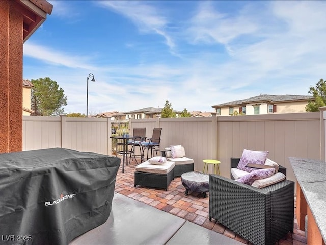 view of patio with outdoor lounge area, a fenced backyard, and grilling area