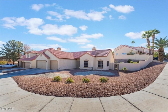 mediterranean / spanish-style home with a garage, driveway, a tile roof, fence, and stucco siding