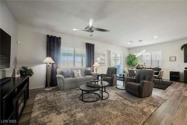 living room featuring recessed lighting, ceiling fan, baseboards, and wood finished floors