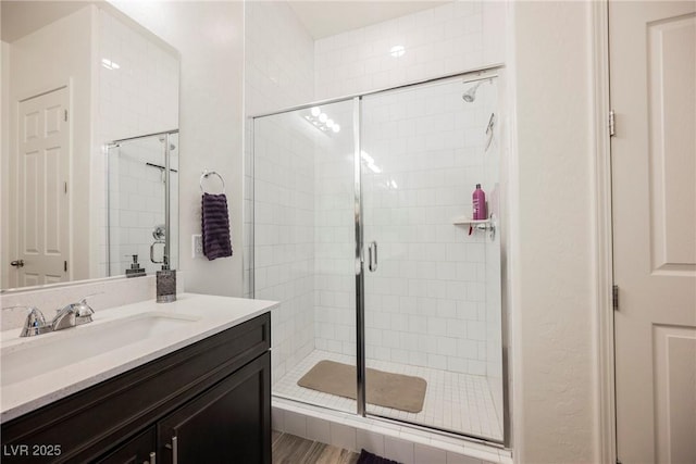 full bathroom with a stall shower and vanity