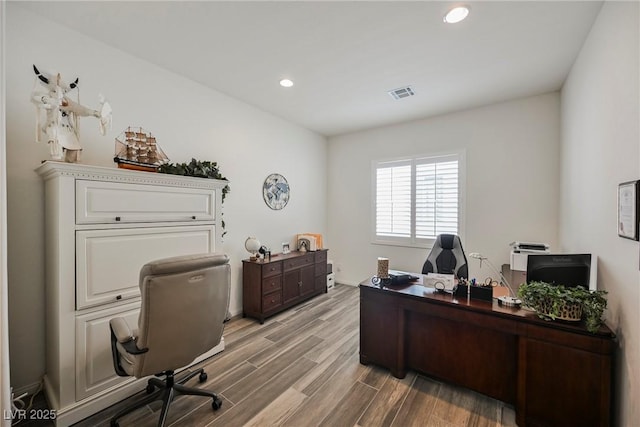 office featuring light wood-style floors, recessed lighting, and visible vents