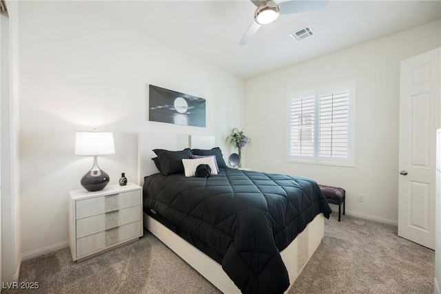 bedroom featuring a ceiling fan, light colored carpet, visible vents, and baseboards