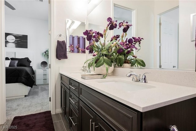 full bath featuring double vanity, a sink, and ensuite bathroom