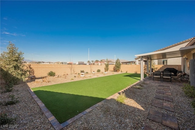 view of yard with a patio area and a fenced backyard