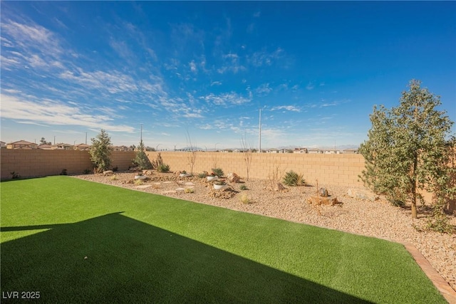 view of yard with a fenced backyard