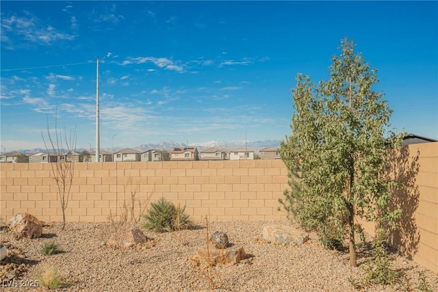 view of yard with a residential view and a fenced backyard