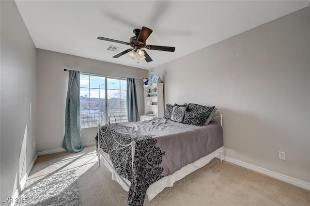 carpeted bedroom with visible vents, ceiling fan, and baseboards