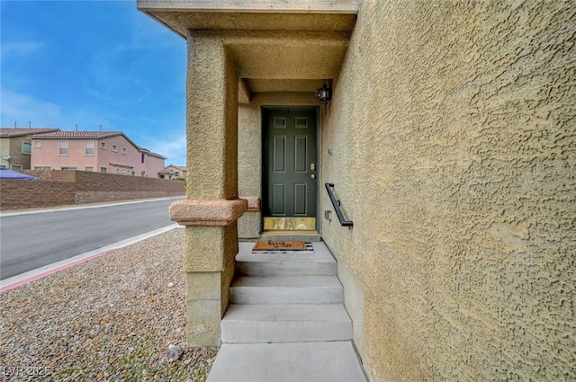 property entrance featuring stucco siding