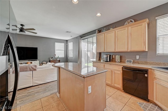 kitchen featuring a wealth of natural light, light brown cabinets, dishwasher, and a center island