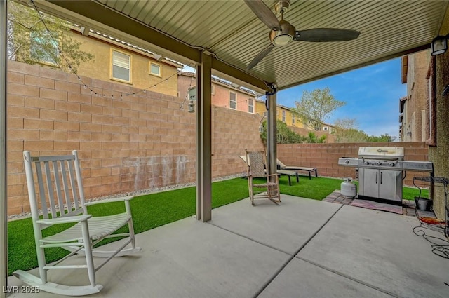 view of patio featuring a ceiling fan and fence