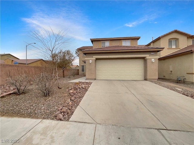 view of front facade featuring driveway, fence, an attached garage, and stucco siding