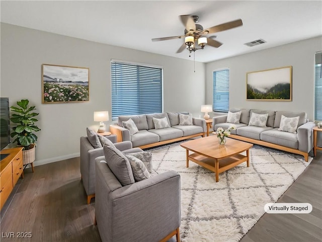 living area featuring ceiling fan, wood finished floors, visible vents, and baseboards