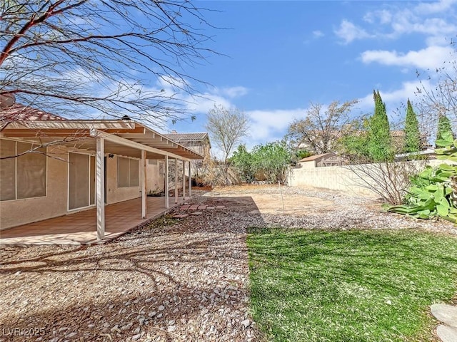 view of yard featuring fence and a patio