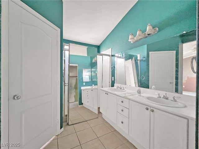 bathroom with double vanity, tile patterned flooring, and a sink