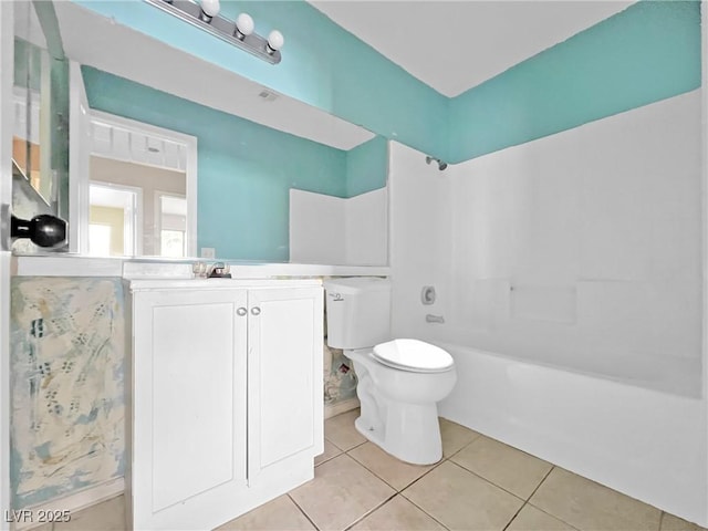 bathroom featuring toilet, vanity, bathing tub / shower combination, and tile patterned floors