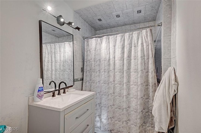 bathroom featuring curtained shower and vanity