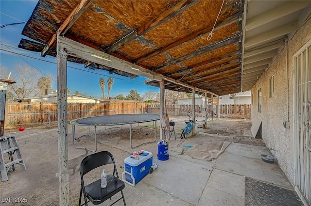 view of patio / terrace featuring a trampoline and a fenced backyard