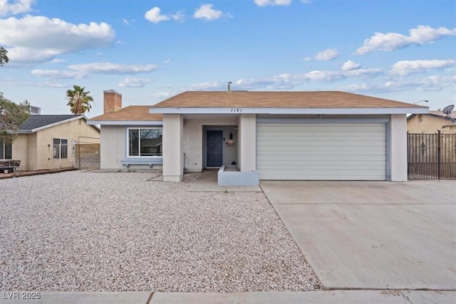 ranch-style home with concrete driveway, a chimney, an attached garage, and fence