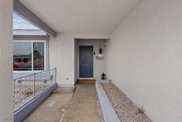 entrance to property with stucco siding