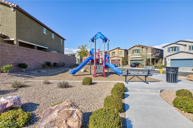 community play area with fence and a residential view