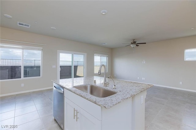 kitchen with visible vents, open floor plan, a kitchen island with sink, a sink, and dishwasher