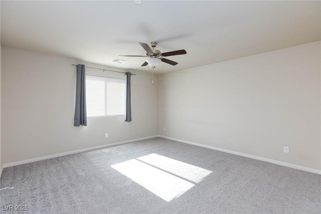 carpeted spare room featuring visible vents, baseboards, and a ceiling fan