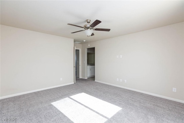 unfurnished room with ceiling fan, baseboards, and carpet flooring