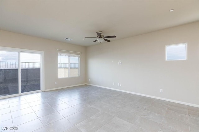 unfurnished room featuring visible vents, baseboards, a ceiling fan, and light tile patterned flooring