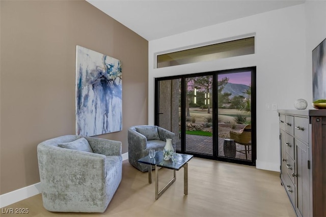 living area with light wood-style floors and baseboards