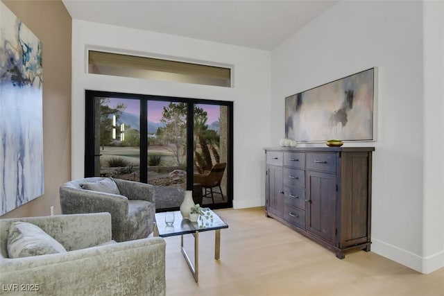 living room with light wood-type flooring and baseboards