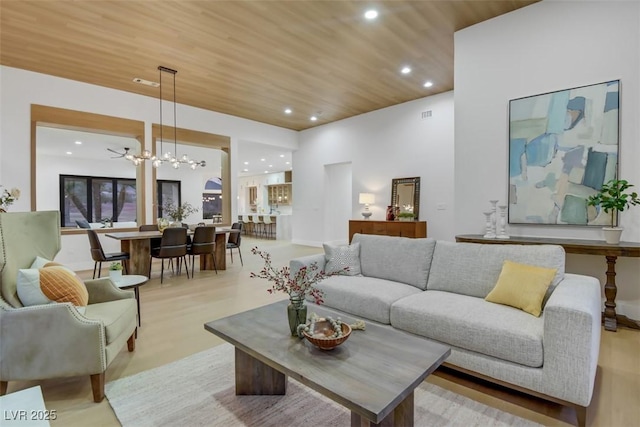 living area with wood ceiling, visible vents, a chandelier, and recessed lighting