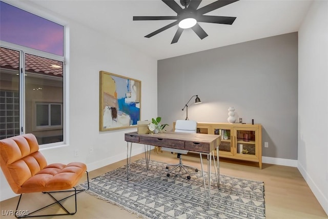 office featuring ceiling fan, baseboards, and wood finished floors