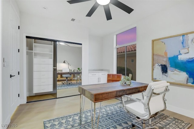 home office with ceiling fan, visible vents, and baseboards