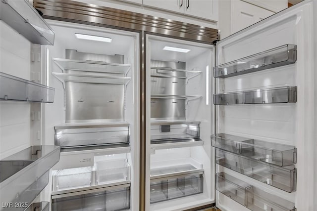 room details featuring white cabinetry and built in fridge