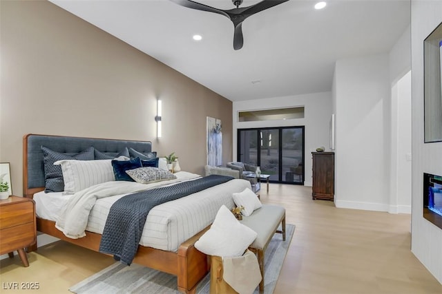 bedroom with ceiling fan, recessed lighting, baseboards, light wood-type flooring, and a glass covered fireplace