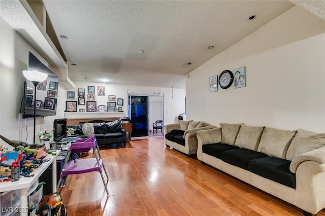 living room featuring a textured ceiling and wood finished floors