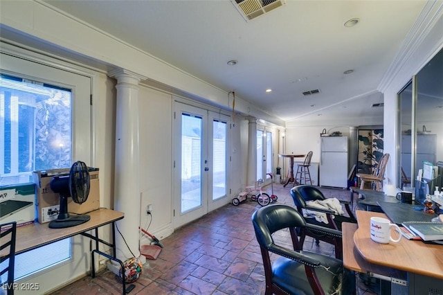 office area with ornate columns, visible vents, crown molding, and french doors