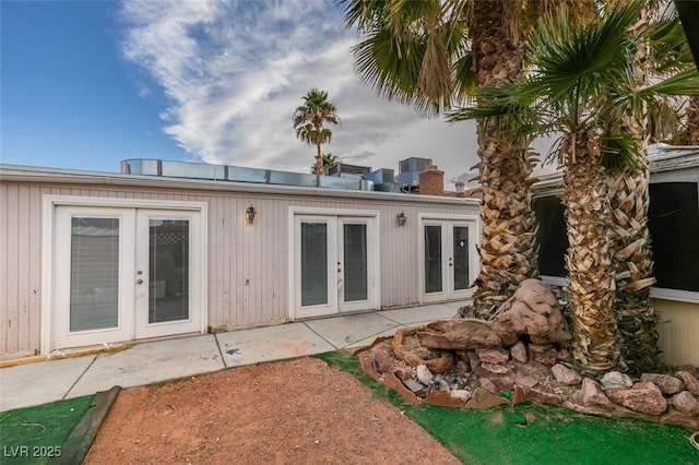 rear view of house with a patio, french doors, and central AC unit