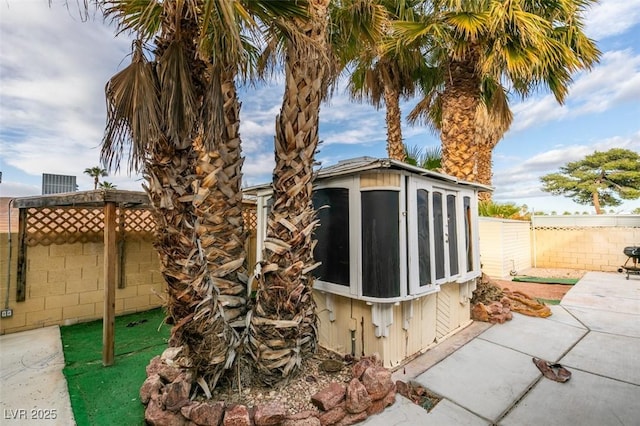 view of outbuilding featuring a fenced backyard and an outdoor structure