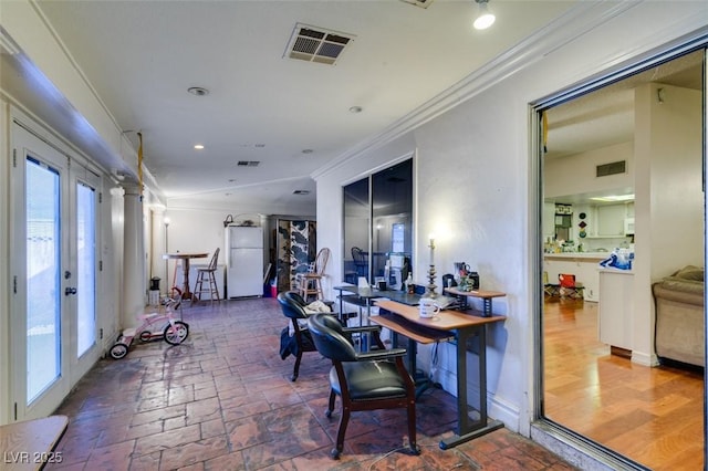 home office with visible vents, french doors, and ornamental molding