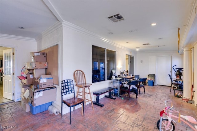 dining space with ornamental molding, stone tile flooring, and visible vents