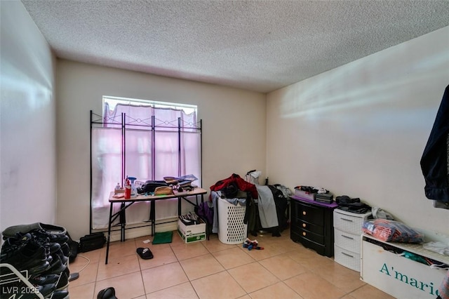 home office with light tile patterned floors and a textured ceiling