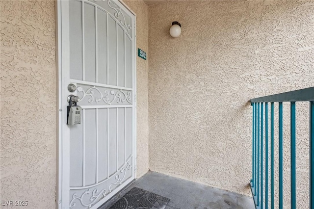 property entrance with stucco siding