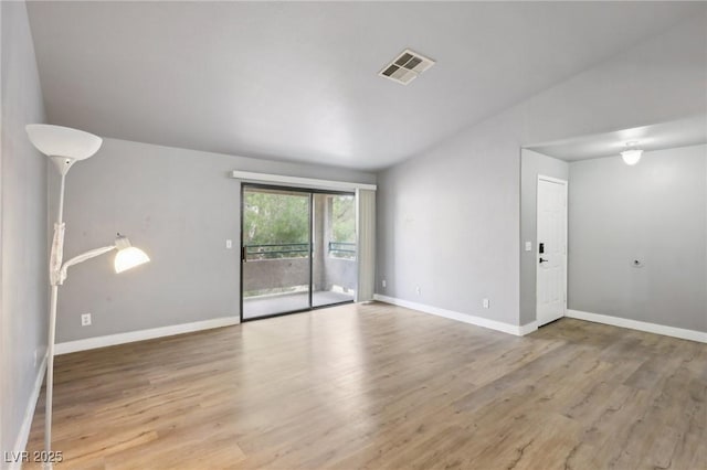 empty room with light wood-type flooring, baseboards, and visible vents