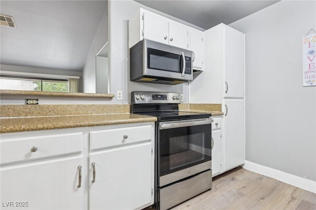 kitchen with visible vents, appliances with stainless steel finishes, light wood-style floors, white cabinetry, and baseboards